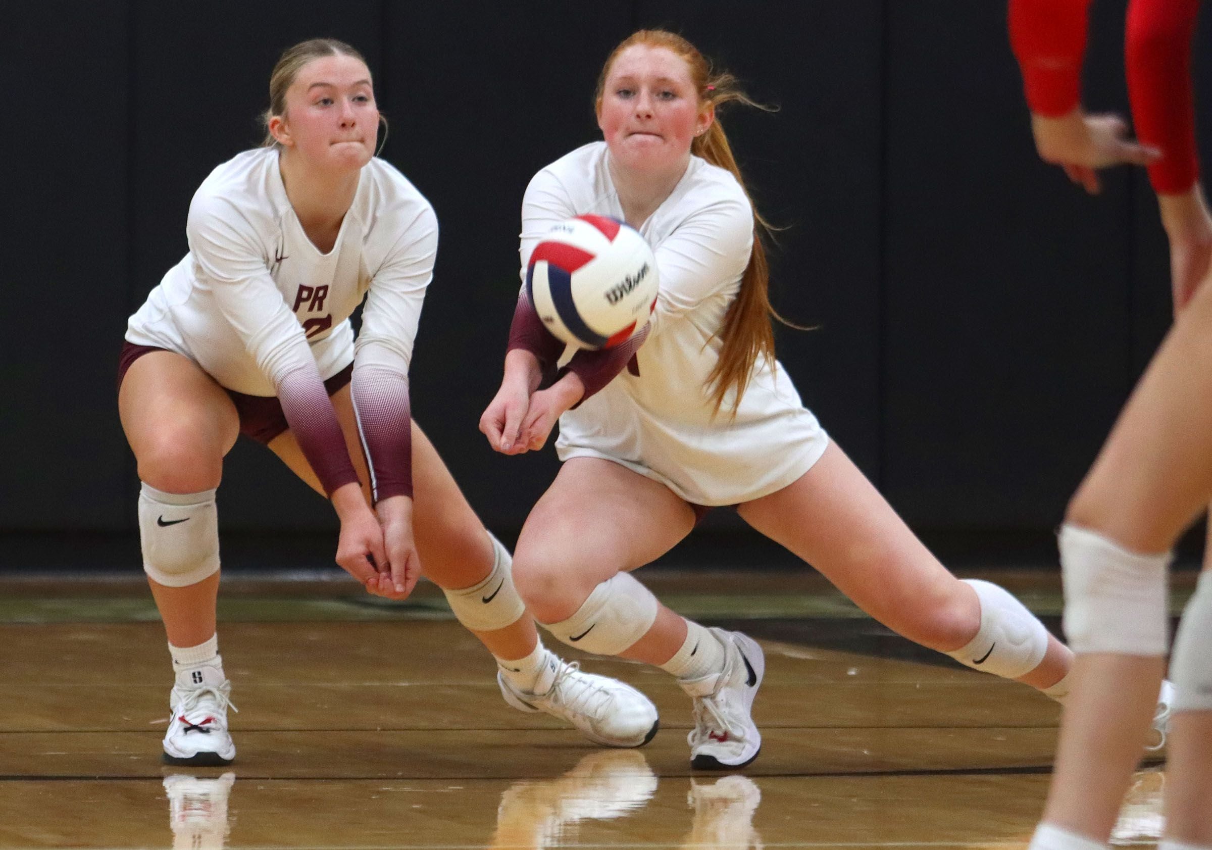 Prairie Ridge’s Ava Bell, left, and Kaelin Bacak play the ball against St. Viator in IHSA Class 3A Super-Sectional girls volleyball at Streamwood High School in Streamwood on Monday, November 10, 2025.
