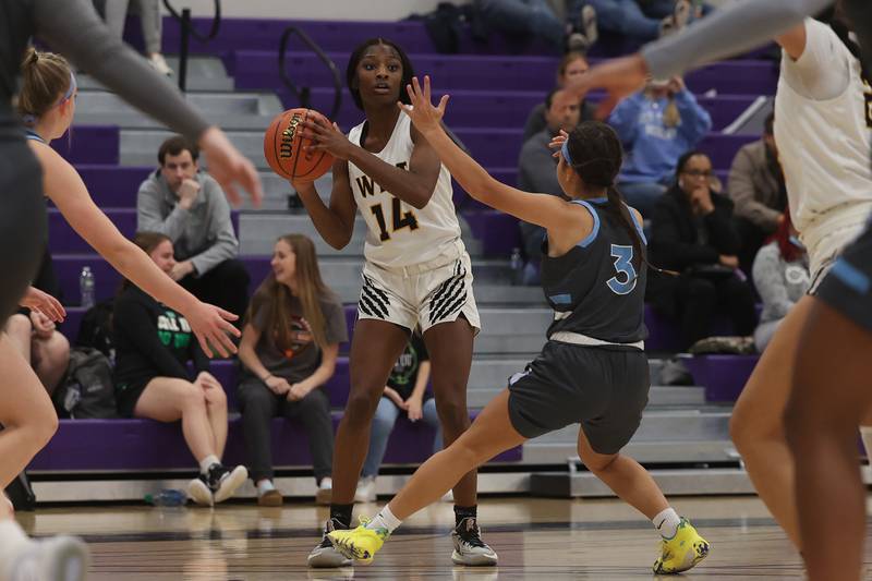 Joliet West’s Destiny McNair looks to pass against Joliet Catholic in the WJOL Basketball Tournament at Joliet Junior College Event Center on Monday