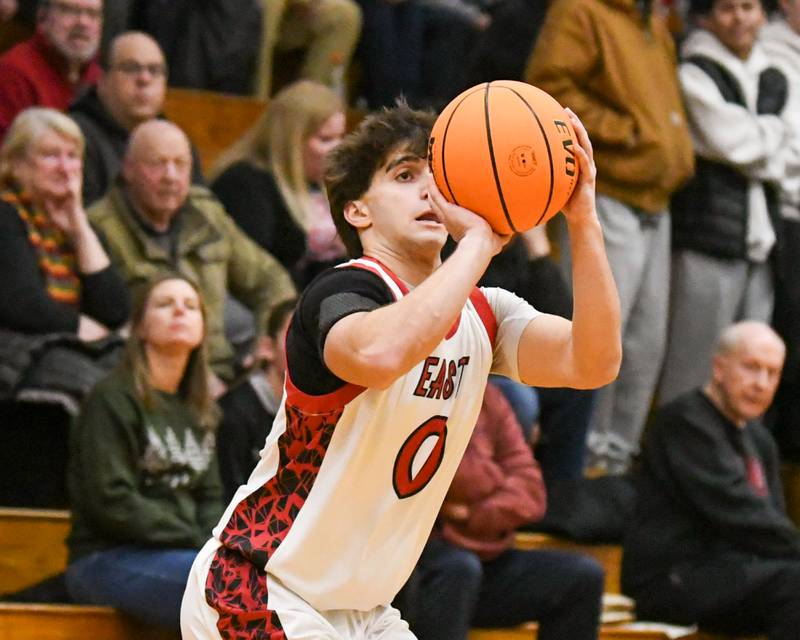 Glenbard East's Muhammed Musleh (0) makes a three-point basket during the game on Friday Dec. 19, 2025, while taking on Riverside Brookfield held at Glenbard East High School.