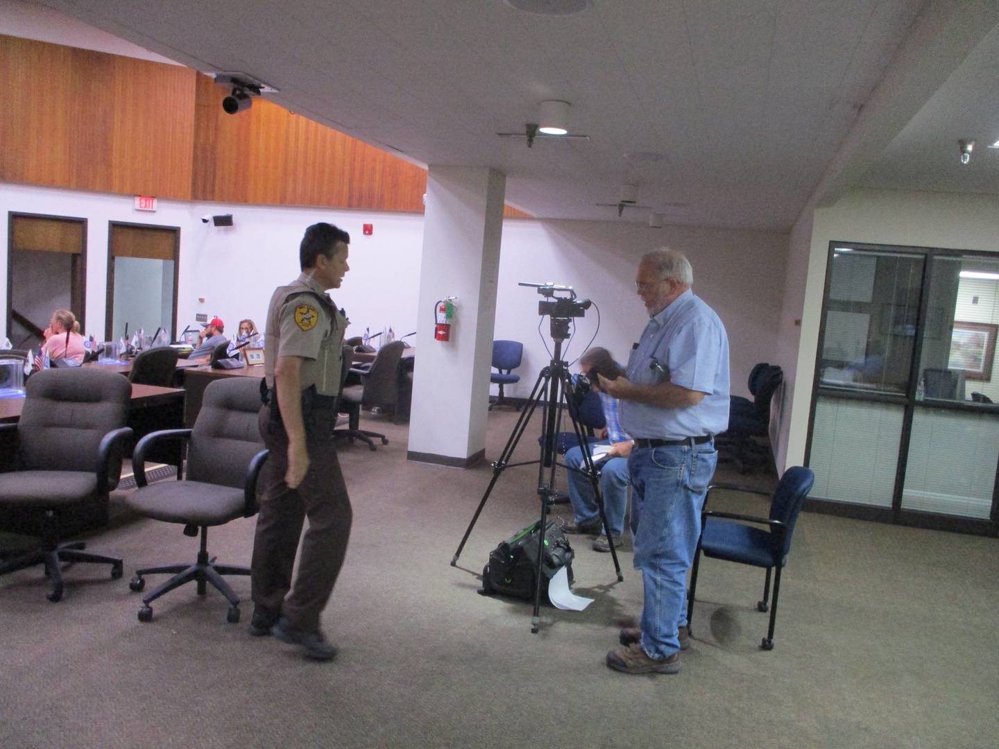 A Will County Sheriff's deputy approaches John Kraft with Edgar County Watchdogs as Kraft was loudly protesting a vote by the Veterans Assistance Commission Executive Board at its meeting on Thursday, Aug. 4, 2022 in Joliet.