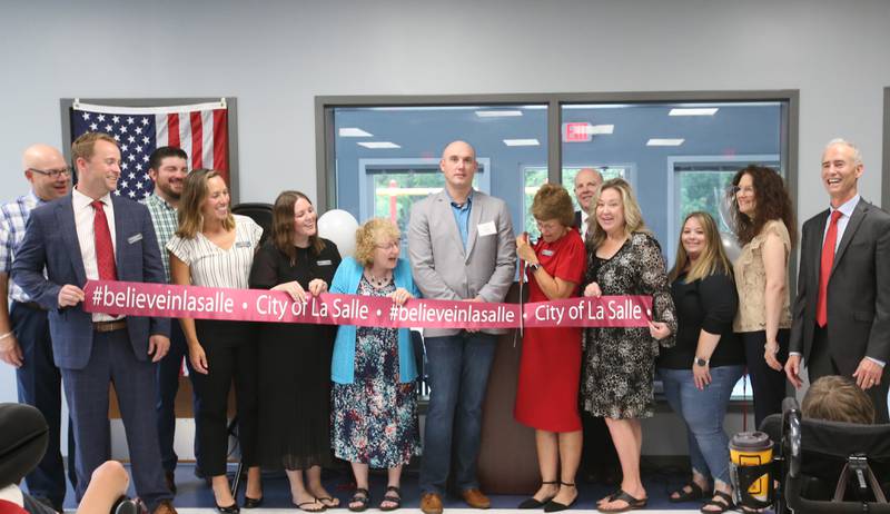 Lighted Way board members cut the ribbon during the ribbon cutting and dedication on Saturday, Aug. 5, 2023 in La Salle.