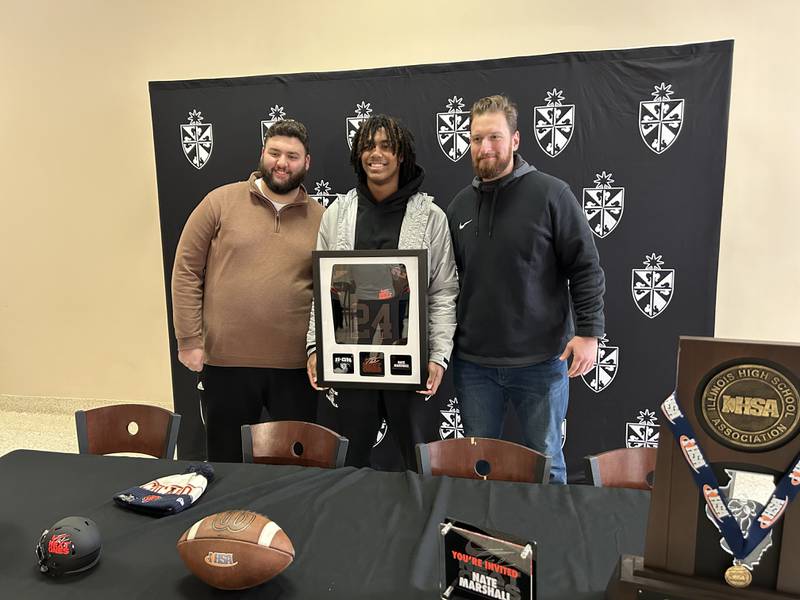 Fenwick's Nate Marshall, center, poses with his Friar coaches during a ceremony Tuesday in River Forest announcing that he'll be the Chicago Bears' representative at next month's Nike Next Ones event in Las Vegas.