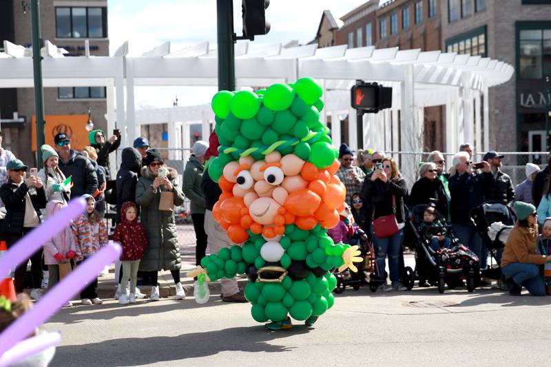 A leprechaun made of balloons greets onlookers during the St. Charles St. Patrick's Parade on Saturday, March 9, 2024.