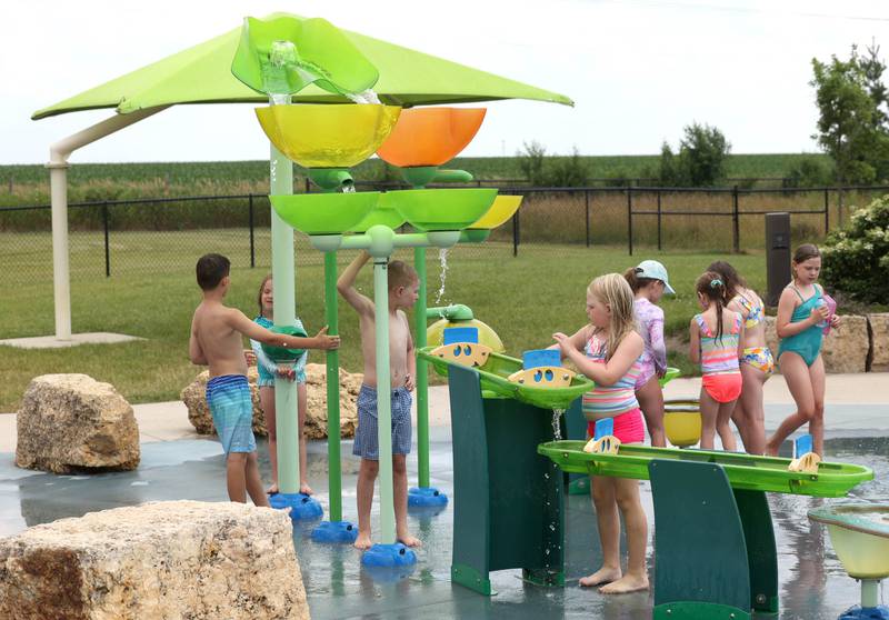 Kids cool off Thursday, June 20, 2024, at Splash Fountain Splashpad at the Sycamore Park District’s Legacy Campus on Airport Road. High temperatures have been over 90 degrees every day this week making splash pads and pools very popular destinations.