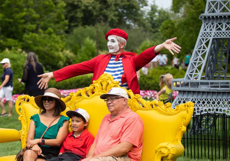 Mark Kasperski, right, and Mark Demitri (10), middle, and Dinah Kaperski of McHenry pose for a photo during the Voyage en France Fest at Cantigny in Wheaton on Sunday, July 16, 2023.