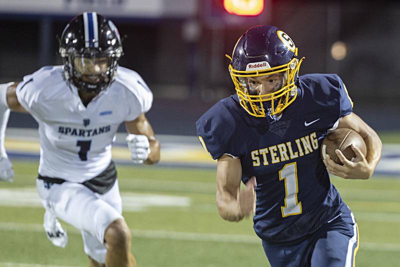 Sterling’s Joseph Holcomb picks up yards Friday, Sept. 1, 2023 against St Francis in a game at Sterling High School.