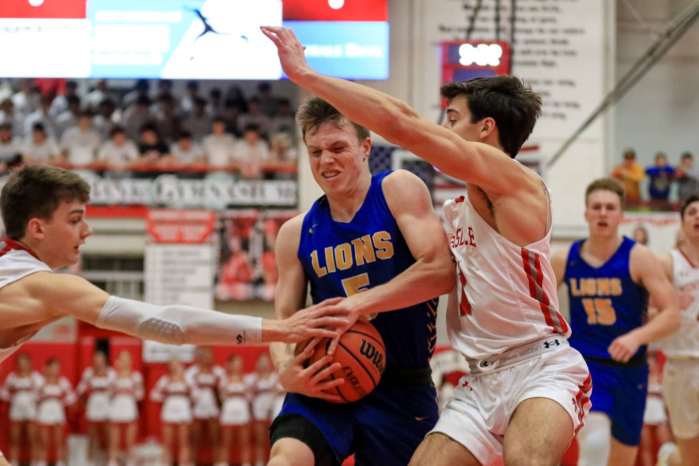 Lyons Jackson Niego (5) holds onto the ball while Hinsdale Central's Ben Oosterbaan (12) attempts a steal during varsity basketball game between Lyons at Hinsdale Central.  Jan 20, 2023.