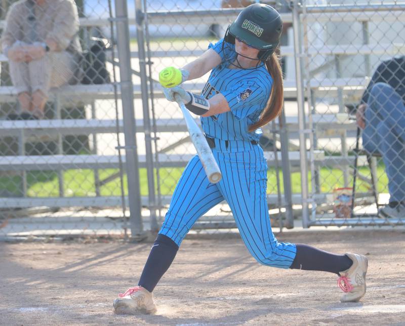 Marquette's Savannah Erickson makes contact with the ball on Thursday, April 23, 2026 at June Cross Field in Ottawa.