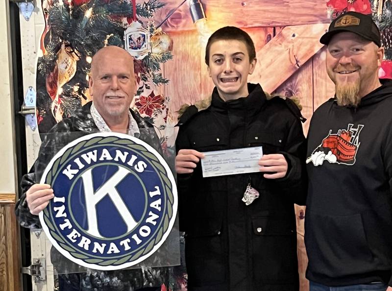 Chris Meyers, president of the Fulton Kiwanis Club. (left) presented the final $1,000 needed for the Fulton High School wrestling program to purchase a new wrestling mat. The mat costs $11,000 and the wrestlers and the Fulton Boosters raised $10,000 themselves and were short $1,000. Pictured with Meyers are Coach Aaron Kuebel, and wrestler Brady Feller.