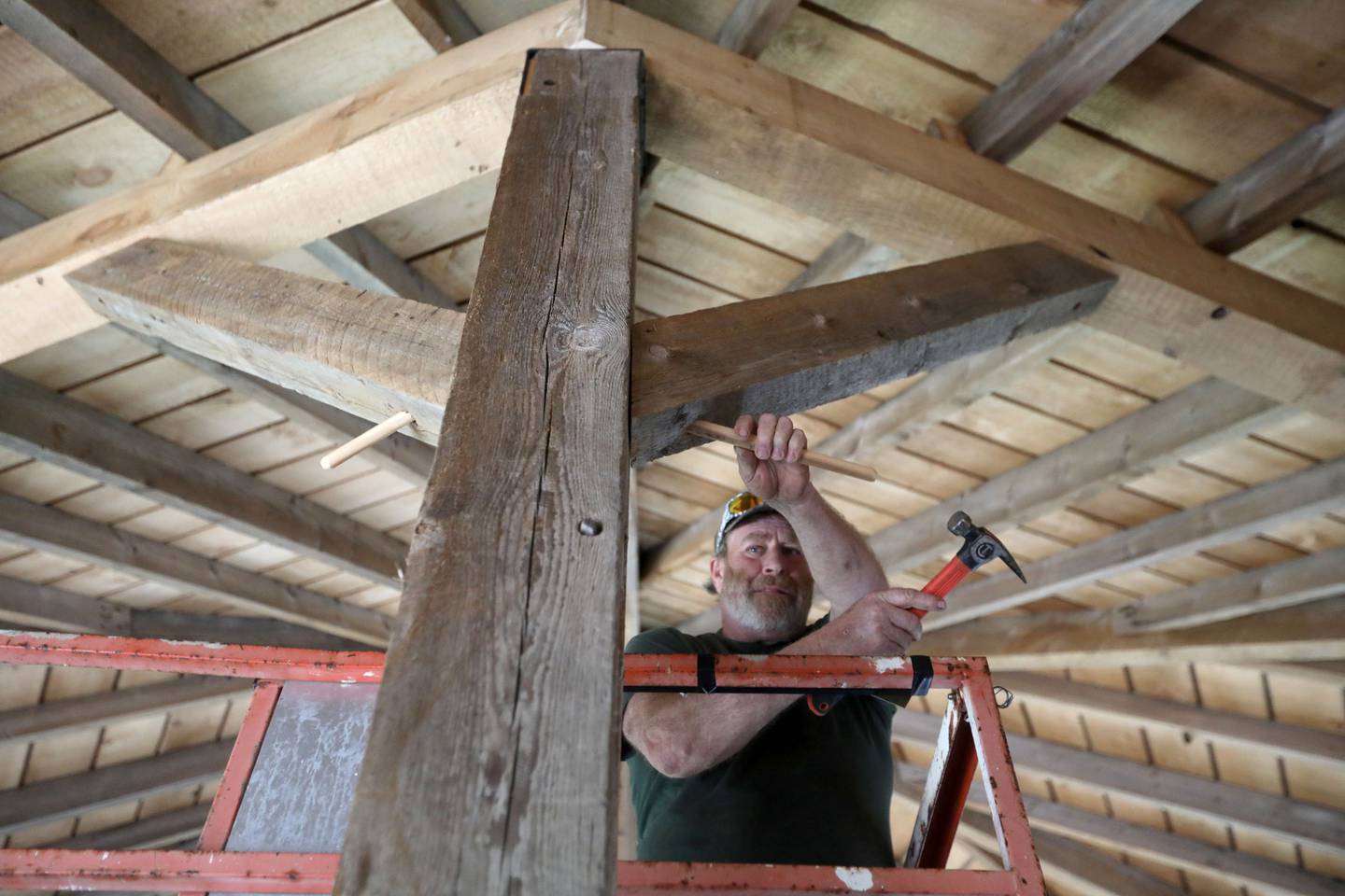 Alex Anderson, a timber smith, works on rebuilding a rare, eight-sided barn on Wednesday, April 22, 2026, at Richardson Adventure Farm in Spring Grove.