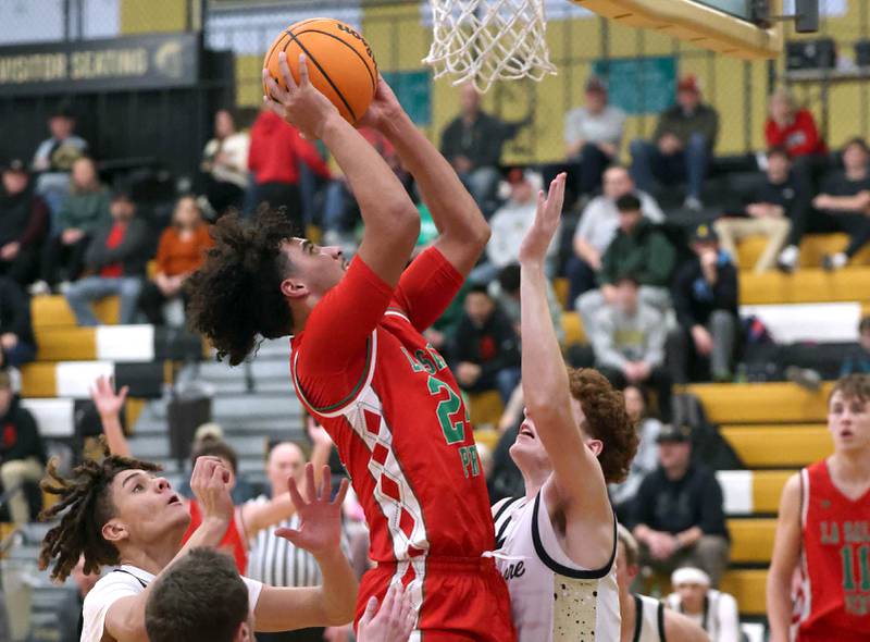 La Salle-Peru's Marion Persich scores over Sycamore's Aidan Mesenbrink during their game Tuesday, Feb. 4, 2025, at Sycamore High School.