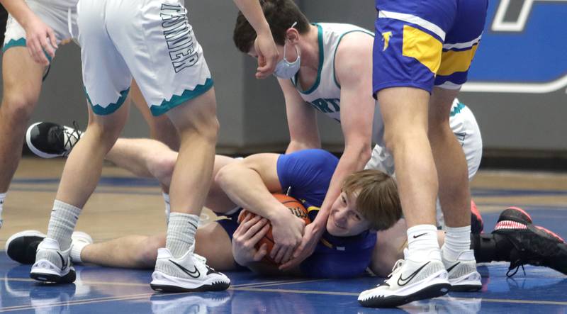 Wheaton North’s Seth Kortenhoeven peeks out as he is pressured by Woodstock North’s Jacob McConnell during MLK Tournament action at Burlington Central High School Saturday morning.