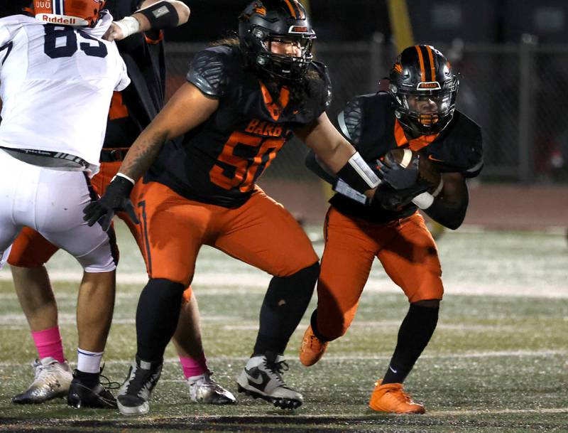 DeKalb's Mariyan Dudley follows the blocking of Jeremiah Pineira through the Stagg defensive line during their game Friday, Oct. 25, 2024, at DeKalb High School.