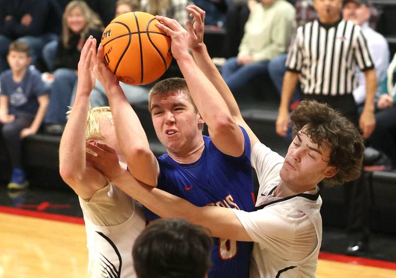 Genoa-Kingston's Nathan Kleba gets caught between two Indian Creek defenders during their game Friday, Jan. 3, 2025, at Indian Creek High School in Shabbona.