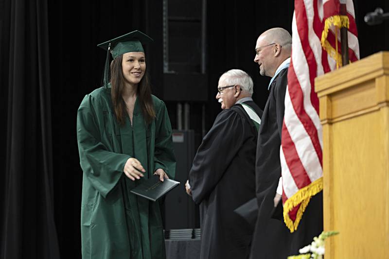 Makenna Arickx crosses the stage after receiving her diploma Sunday, May 28, 2023 at Rock Falls High School’s 144th commencement ceremony.