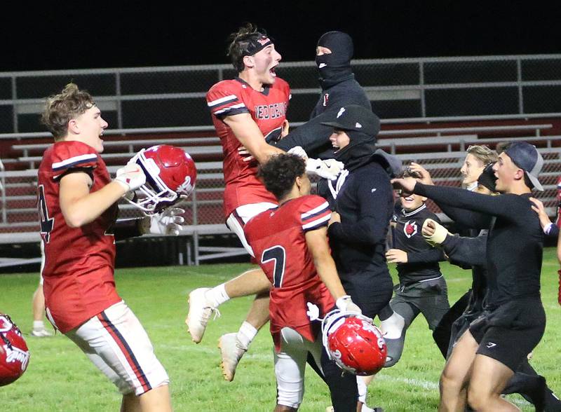 Hall football players (from left) Chace Sterling, Braden Curran and Cameron Allison react with super fans after defeating Sherrard during Homecoming night on Friday, Sept. 19, 2025 at Richard Nesti Stadium.