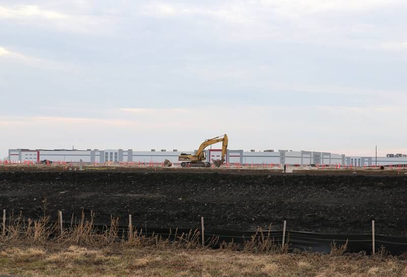 Grading and preparations for building construction are underway Tuesday, Dec. 14, 2021, on the plot of land at the corner of East Gurler Road and Crego Road in the ChicagoWest Business Center in DeKalb. Amazon recently paid $6.3M for the 59 acre parcel. The building in the background is the Ferrara Candy Company.
