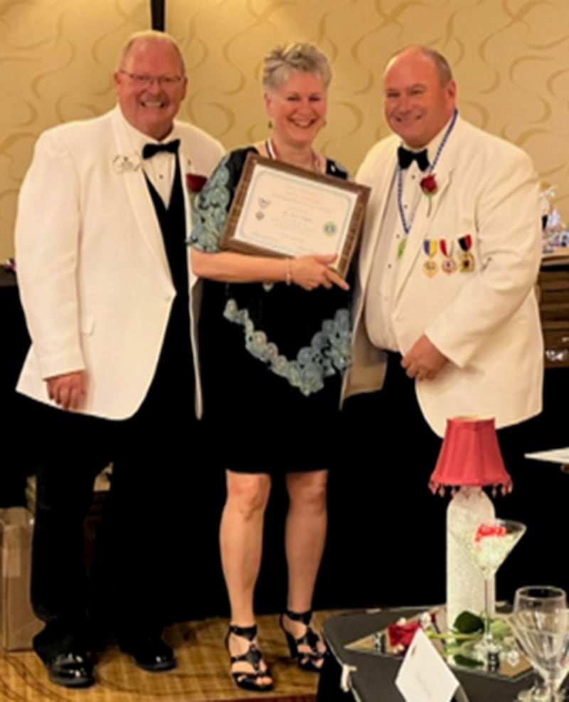 Elburn Lions Club member Linda Callaghan recently received the George Lazansky Distinguished Service Award at the annual 1-J District Convention.  
Photo left to right:  Lion Bruce Beck, Lion Linda Callaghan, and Governor Lion Jim Kiser.