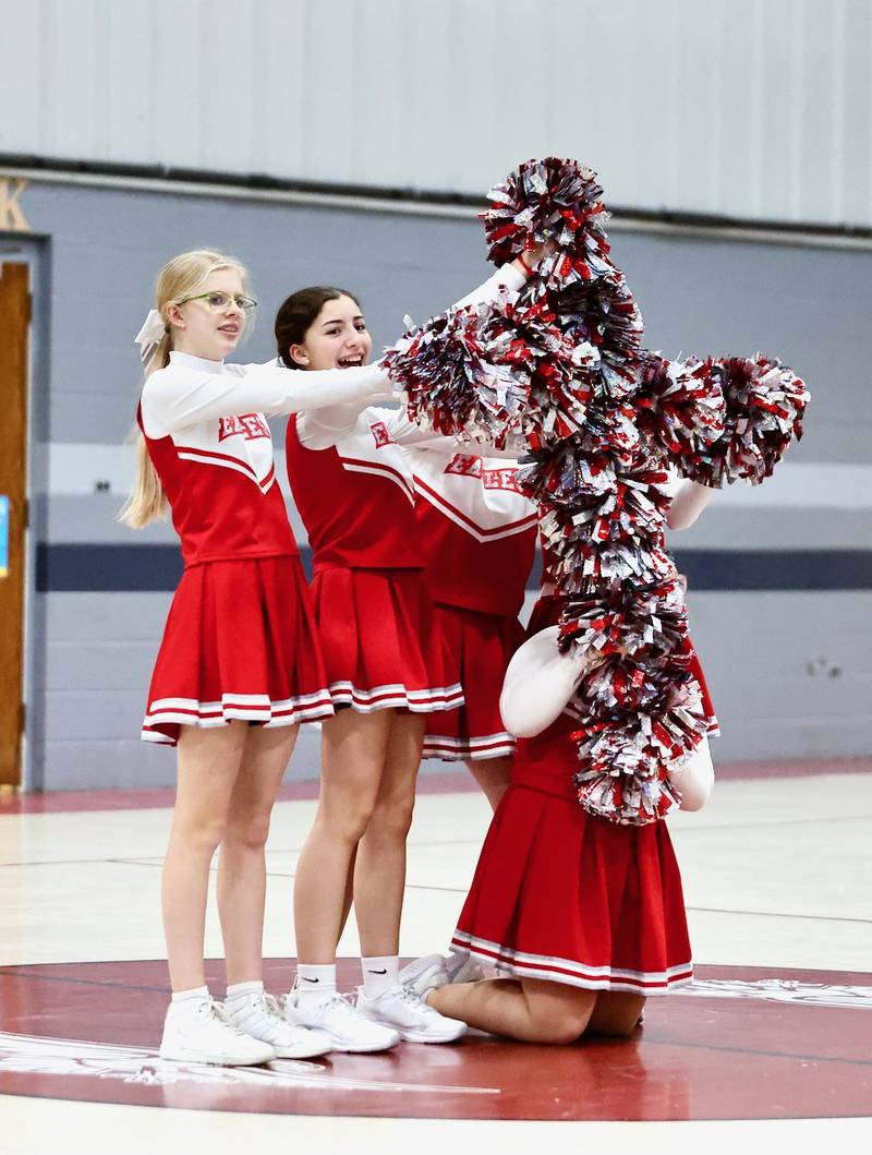 The Princeton Christian Academy cheerleaders lead the cheers in Tuesday's high school boys basketball game at Howard Hoffman Memorial Gymnasium.
