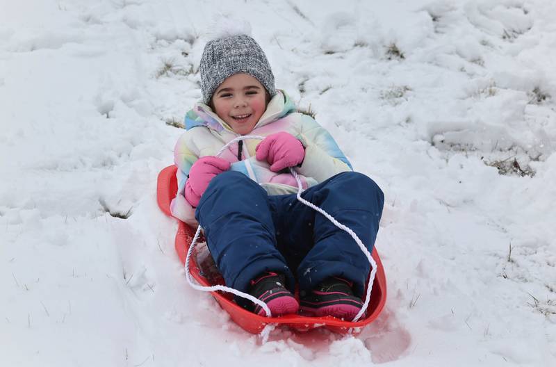 Lexie Hernandez, 6, from DeKalb, takes a ride on the DeKalb Park District sled hill Wednesday, Jan. 25, 2023, in Sycamore.