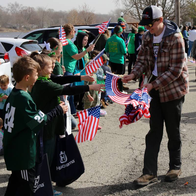 American flags were passed out to kids during the St. Patrick's Day Parade in Yorkville on Saturday, March 15, 2024.