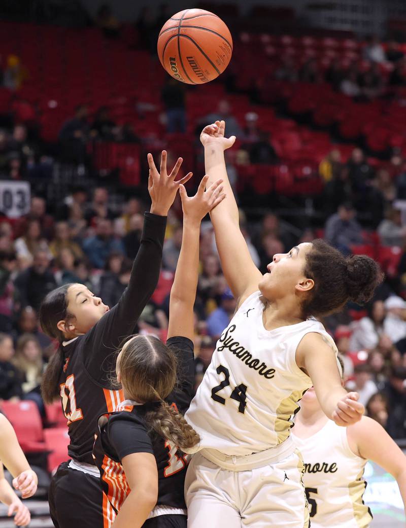 Sycamore's Monroe McGhee grabs a rebound over two DeKalb defenders during the First National Challenge Friday, Jan. 27, 2023, at The Convocation Center on the campus of Northern Illinois University in DeKalb.