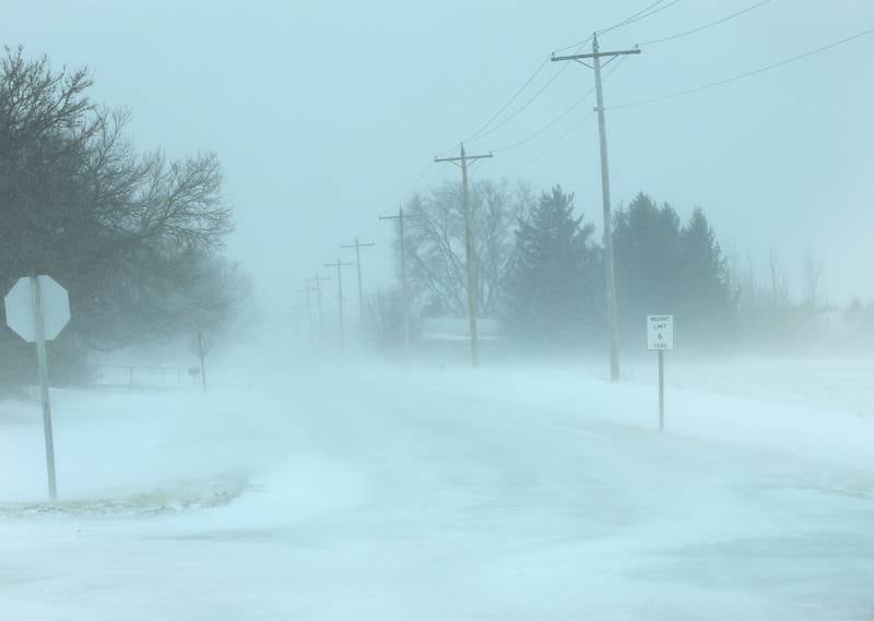 Snow blows across East 11th road where it intersects with U.S. Highway 6 along the Osage Curves on Monday, March 16, 2026 near Utica.
