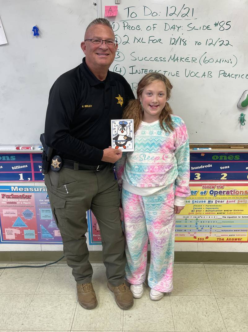 Coal City Intermediate School student Hailey Fisher's holiday greeting design was selected for this year's card for the Grundy County Sheriff's Department. Sheriff Ken Briley visited Fisher and her classmates in Mr. Leve's class prior to the holiday. The winning design was featured on the 250 cards the sheriff's office sends out each year and won Fisher and her class a pizza party courtesy of Sheriff Briley.