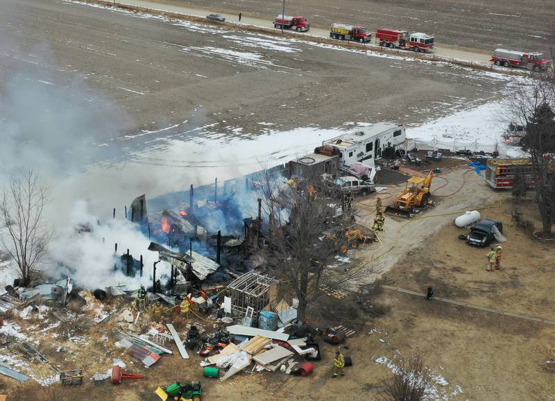 Firefighters extinguish flames from a structure fire in the 4000 block of East 16th Road on Thursday, Feb. 5, 2026 near Earlville. Fire departments from Serena, Mendota, Troy Grove and others were dispatched shortly after 12p.m. to the fire. The fire was upgraded to the second alarm through the Mutual Aid Box Alarm System (MABAS 25) shortly after.