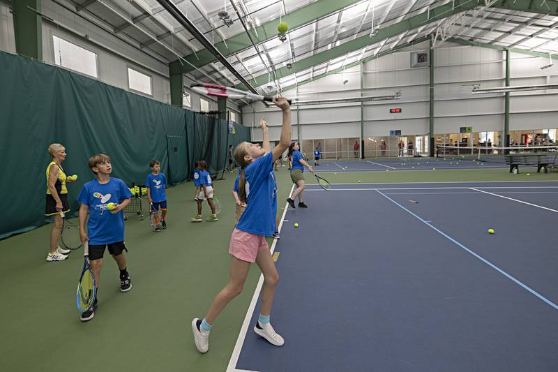 Tennis campers at Westwood practice their serves Thursday, June 29, 2023. The sports facility held a free tennis camp for kids 7-14 to provide participants with a fun introduction to the sport. Players learned skills and other aspects of the game and were also presented with a t-shirt and a goodie bag.