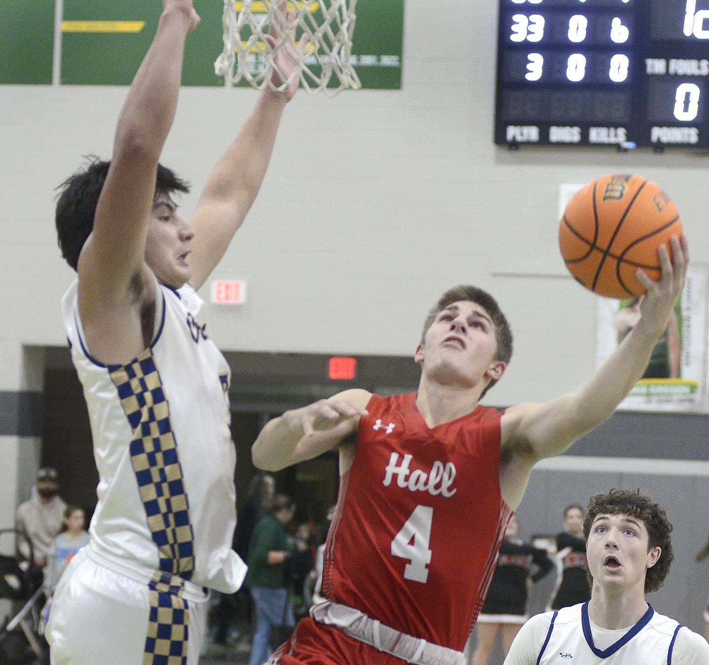 Hall’s Luke Bryant (4) goes around Marquette’s Slayden Cassel for a layup Saturday, Dec. 27, 2025, in the third-place game of the Seneca Shipyard Showdown.