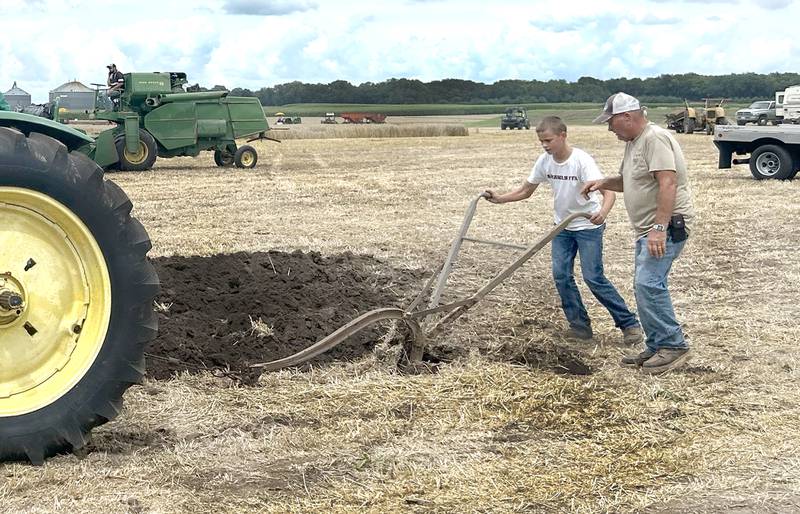 Bennett Sierens, 15, of Annawan, uses a John Deere hand plow at the Bos Brothers Historical Farm south of Erie on Friday, July 25, 2025.