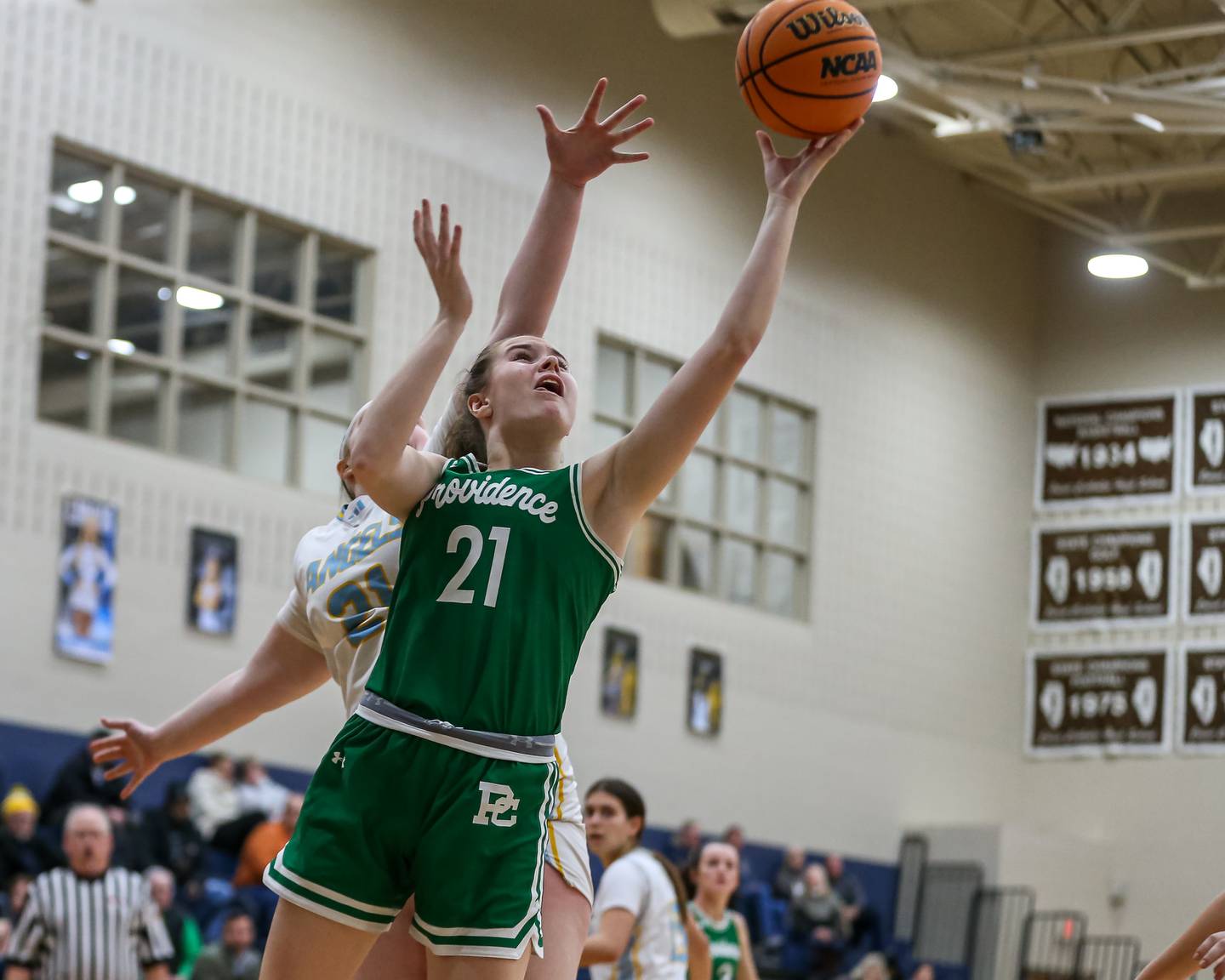 Providence Catholic's Taylor Healy (21) puts in a layup during their basketball game between Providence Catholic at Joliet Catholic. Feb 11, 2025 in Joliet.