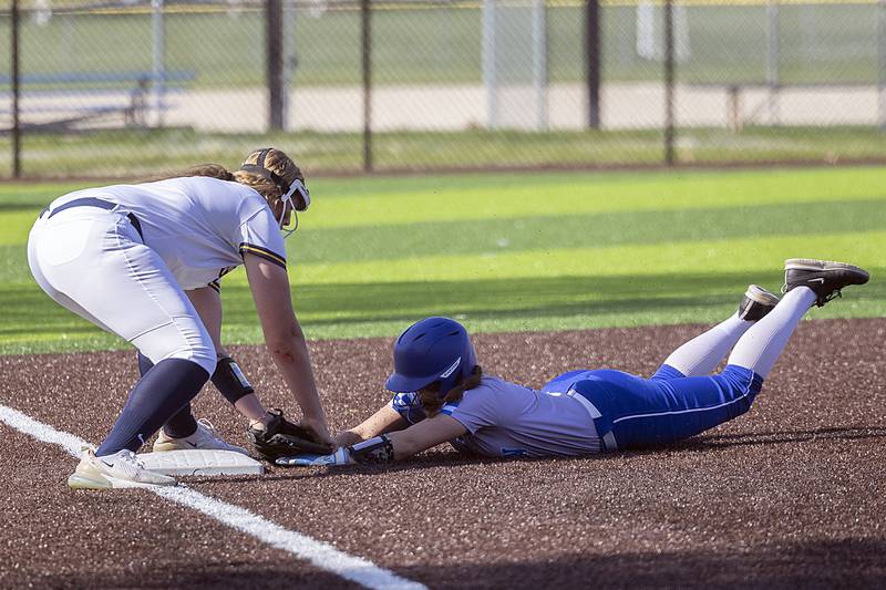 Newman’s Lucy Oetting is tagged out at third against Sterling Thursday, April 27, 2023.