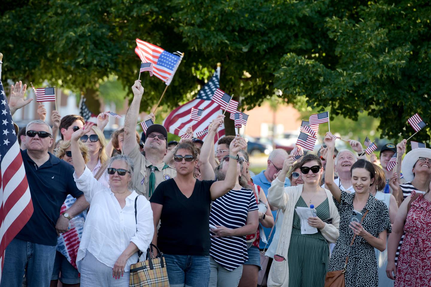 Audience members wave American Flags during the The Fox Valley Patriotic Organization and the Batavia Flag Day Committee groundbreaking ceremony for a Flag Day Monument on Tuesday, June 14, 2022.