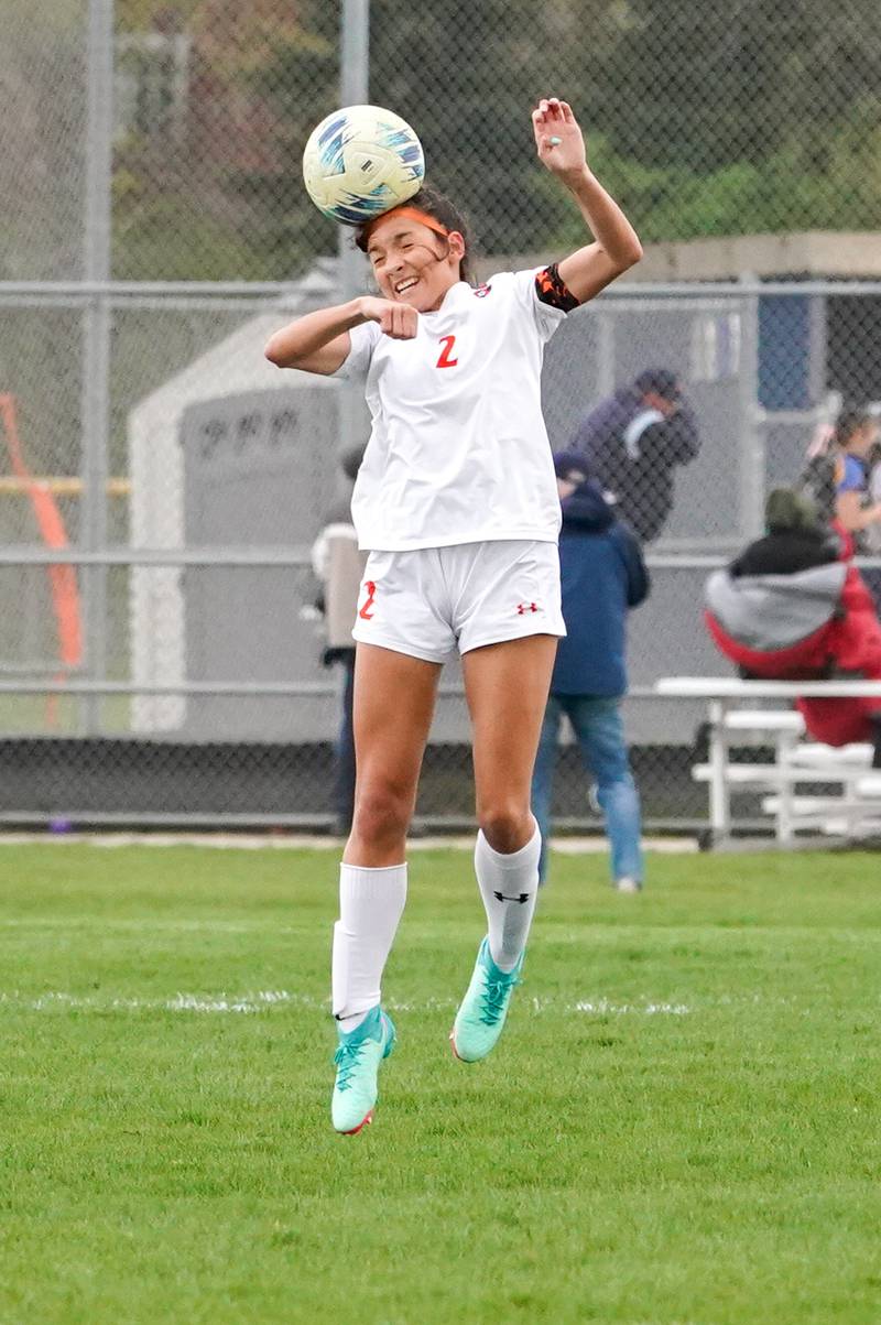 Oswego’s Grace Braun (2) goes up for a header against Oswego East during a soccer match at Oswego East High School on Tuesday, April 23, 2024.