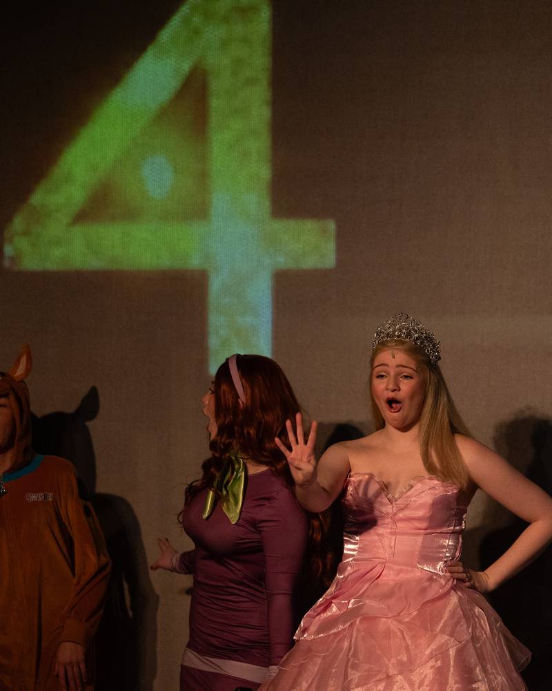 'Princess Glinda' (portrayed by Nora Maier) holds up 4 fingers as counter counts down from 10 before signaling 'New Year' during performance of "New Year, New Friends" on Saturday, December 27, 2025 at Stage 212 in LaSalle.