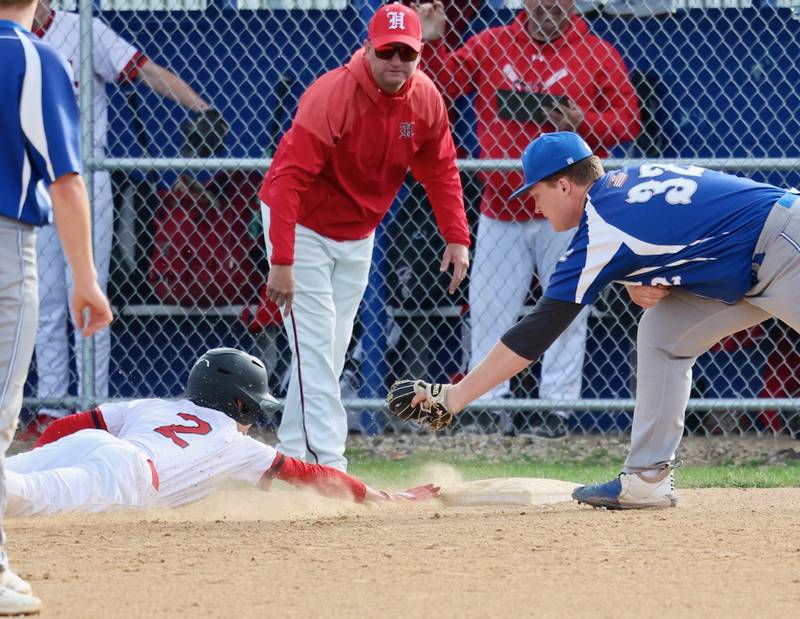 Hall coach Tom Keegan watches as Jimmie Jablonski beats the throw to Princeton third baseman Luke Smith Monday at. Prather Field. The Red Devils won 10-4.