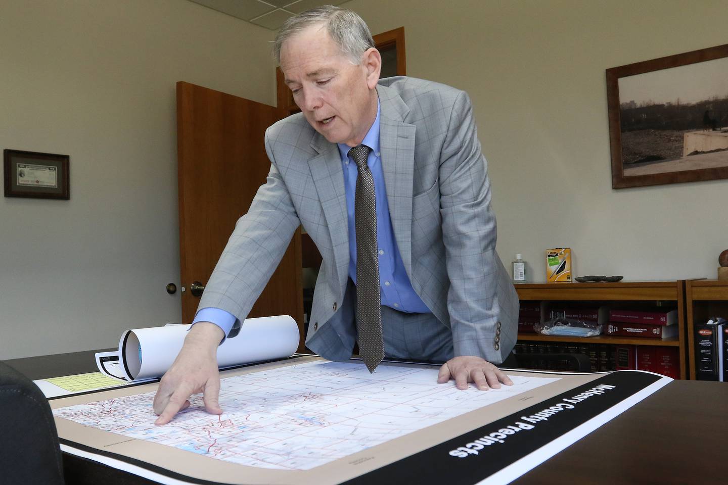 McHenry County Board member Joe Gottemoller shows a current map of McHenry County voter districts and precincts on Friday, April 30, 2021, in Crystal Lake. The county is considering redistricting and is awaiting updated census information.