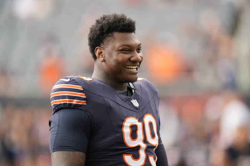 Chicago Bears defensive tackle Gervon Dexter Sr. smiles on the bench during an NFL preseason football game against the Cincinnati Bengals on Saturday, August 17, 2024, at Soldier Field in Chicago. (AP Photo/Charles Rex Arbogast)