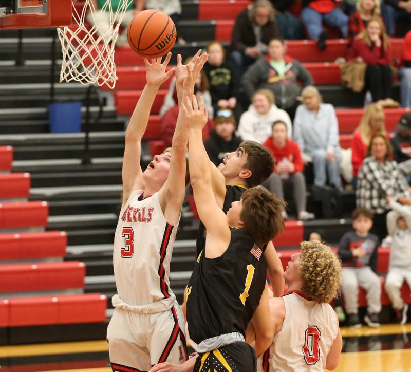 Putnam County's Jackson McDonald (23) runs past Hall's Payton Dye (32) to score a basket during the Colmone Classic on Tuesday, Dec. 6, 2022 at Hall Hight School in Spring Valley.