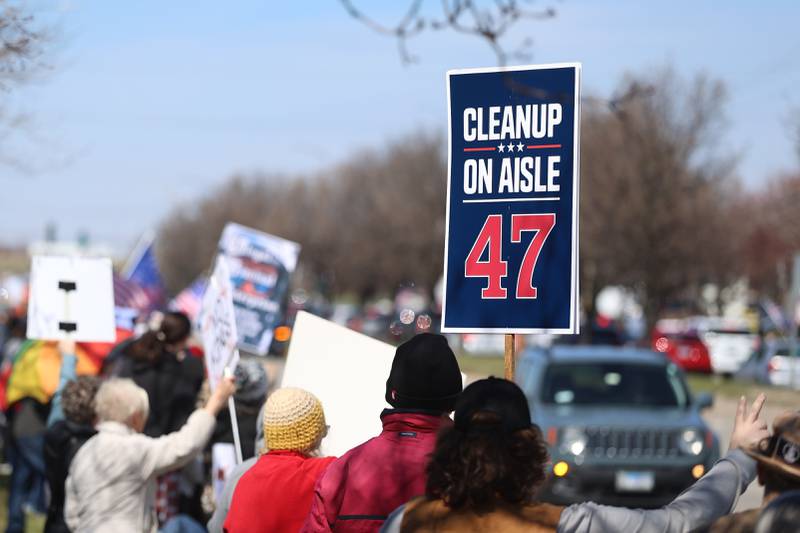 A protestor gets creative with a sign along Plainfield Road at the No Kings rally on Saturday, March 28, 2026 in Joliet.