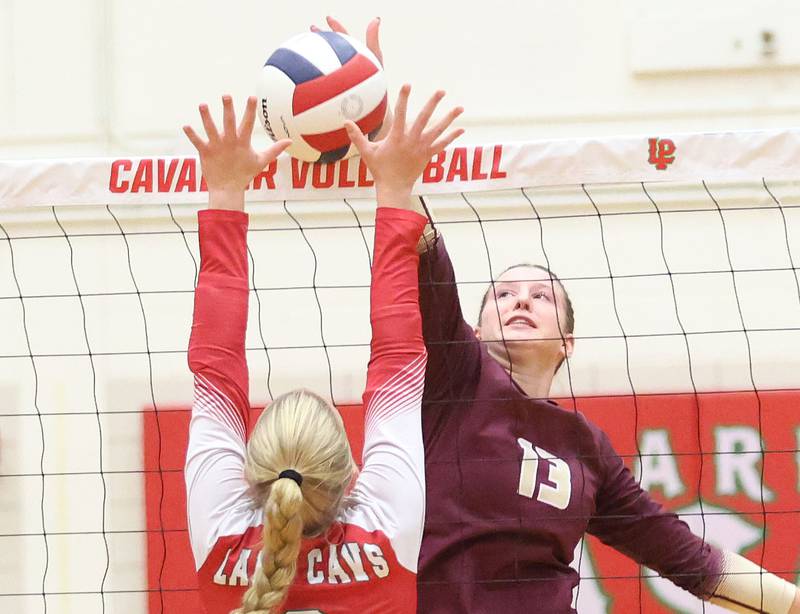 Morris's Lily Hansen's spike is blocked by L-P's Aubrey Urbanski during the Class 3A Sectional semifinal game on Tuesday, Nov. 4, 2025 in Sellett Gymnasium at L-P High School.