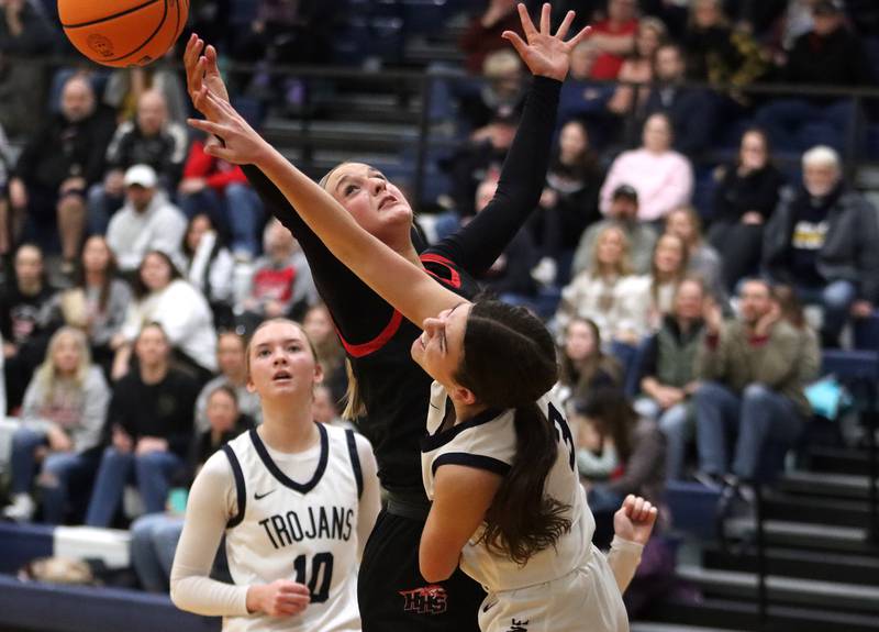 Huntley’s Anna Campanelli works under the hoop against Cary-Grove’s Kennedy Manning, front, in varsity girls basketball on Friday, Jan. 24, 2025, at Cary-Grove High School in Cary.