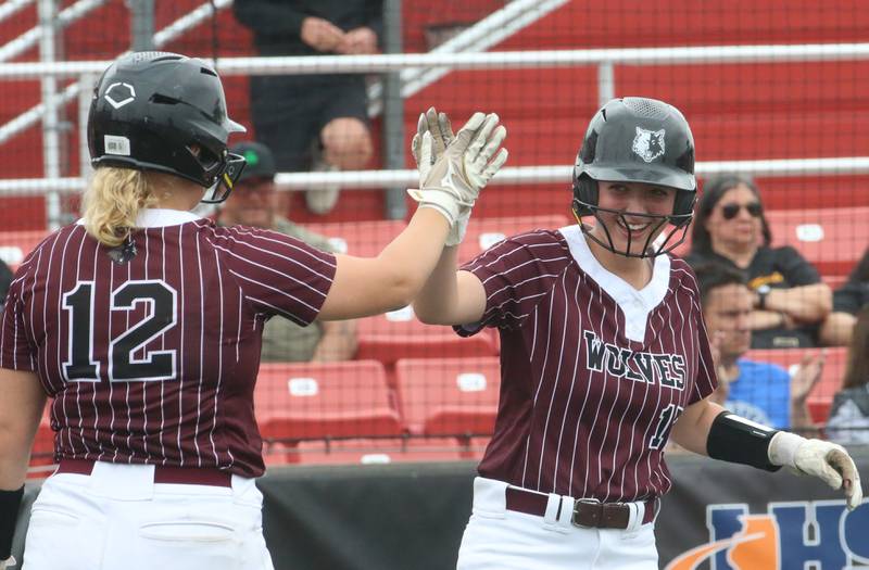 Prairie Ridge's Bella Moore hi-fives teammate Parker Frey after scoring a run against Burbank St. Laurence during the Class 3A State third place game on Saturday, June 14, 2025 at the Louisville Slugger Sports Complex in Peoria.