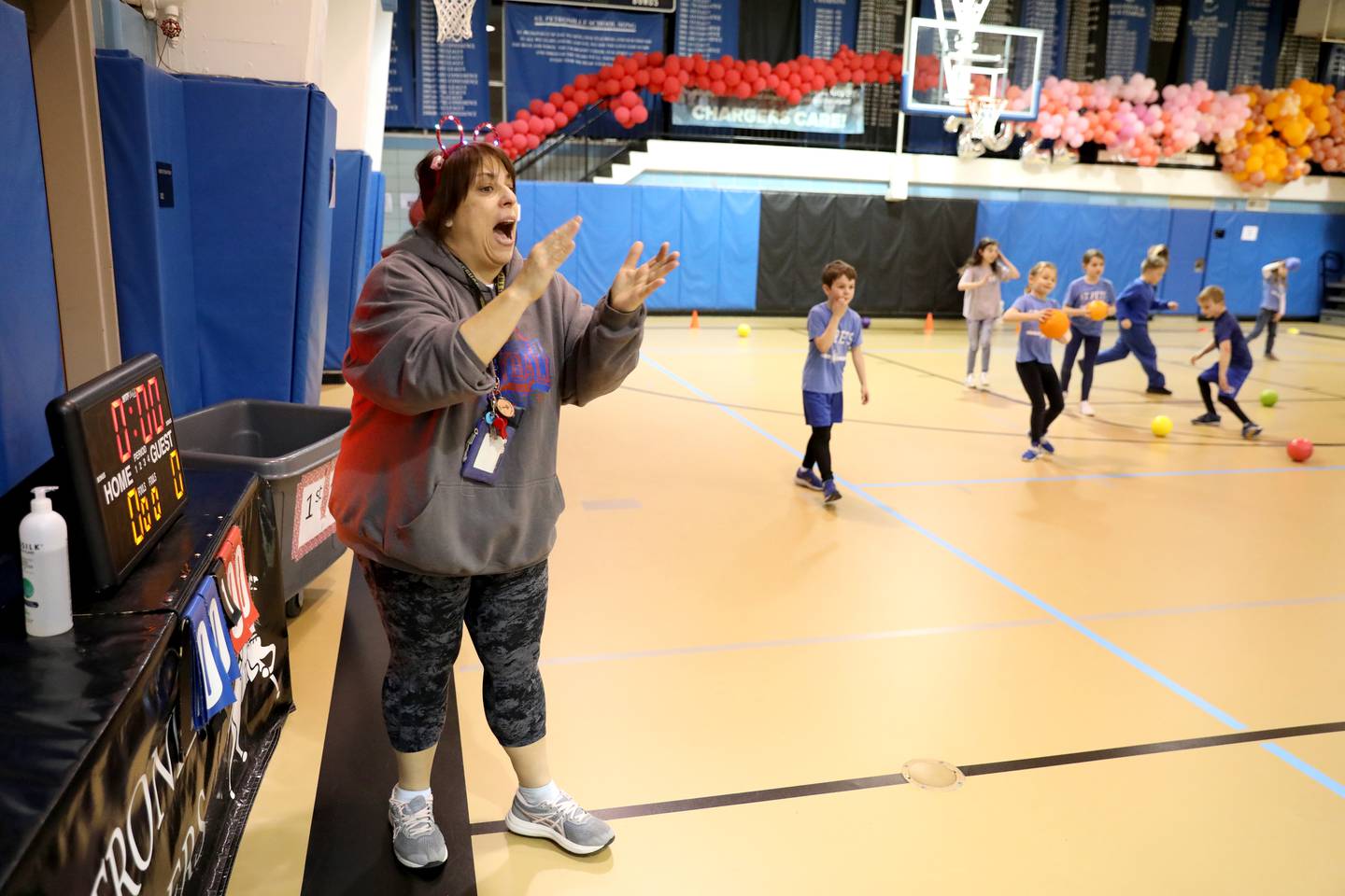 Physical education teacher Christine Giunta-Mayer laughs and dances with her students at St. Petronille Catholic School in Glen Ellyn.