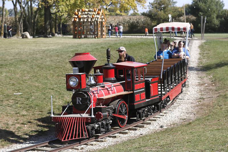 People enjoy a train ride on Monday, Oct. 10, 2022, at Richardson Adventure Farm, 909 English Prairie Road in Spring Grove. The farm's main attraction is a James Bond-themed corn maze, but it also features a 50-foot observation tower, train rides, a carousel, picnic areas, wagon rides, a zip line, 150- and 100-foot slides, zorbing, a petting zoo, pumpkin patch, goat feeding area, pedal kart tracks, live music on weekends, a kid's play area, jumping pillows, pig races, air cannons, a paintball shooting gallery, indoor restrooms, gift shop and wine tasting bar.