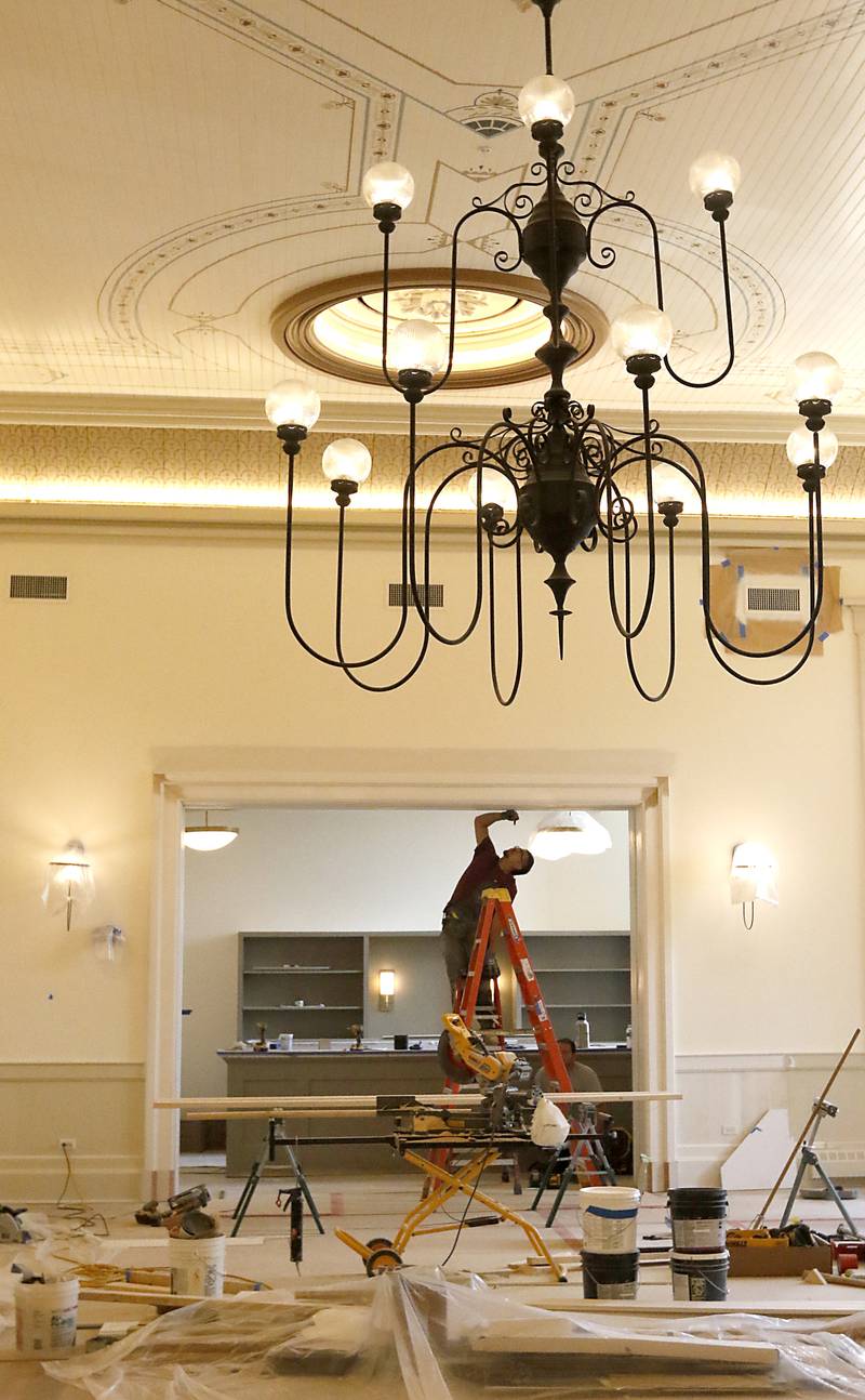 Finishing touches are done in the former courtroom of the he newly remodeled Old Courthouse Center in Woodstock on Thursday, July 13, 2023, during a tour of the building.