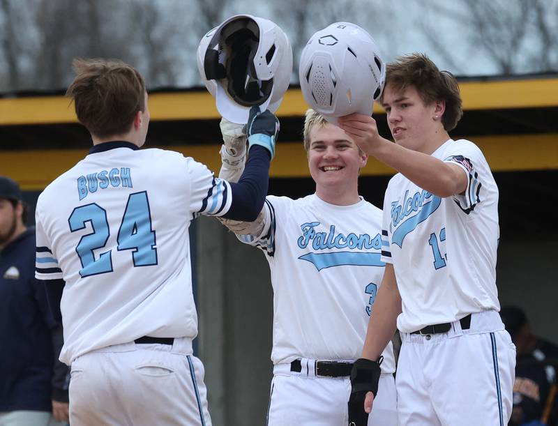 Parkview Christian Academy's Matthew Busch (left) is greeted at the plate by teammates Oliver Malkowski and Christian Mulder (right) after homering Thursday, April 17, 2025, during their game at Hiawatha High School in Kirkland.