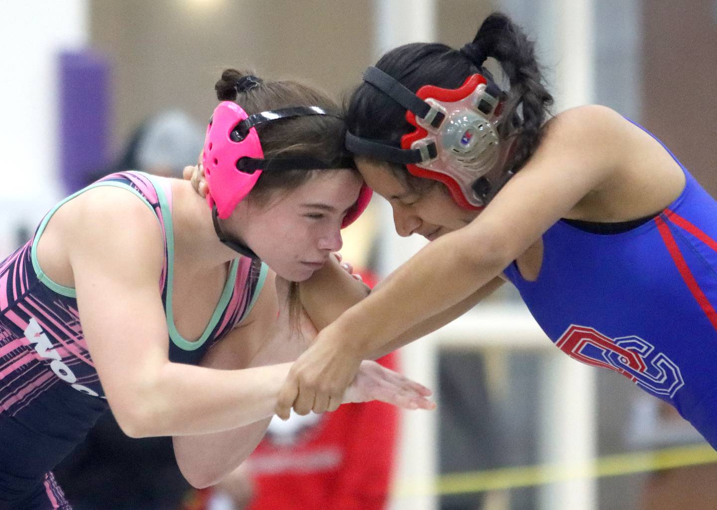 Woodstock’s Eva Hermansson, left, battles Dundee-Crown’s Iris Torres at 110 pounds in IHSA Regional wrestling semifinal action on Saturday, Feb. 1, 2025, at  Hampshire High School  in Hampshire.